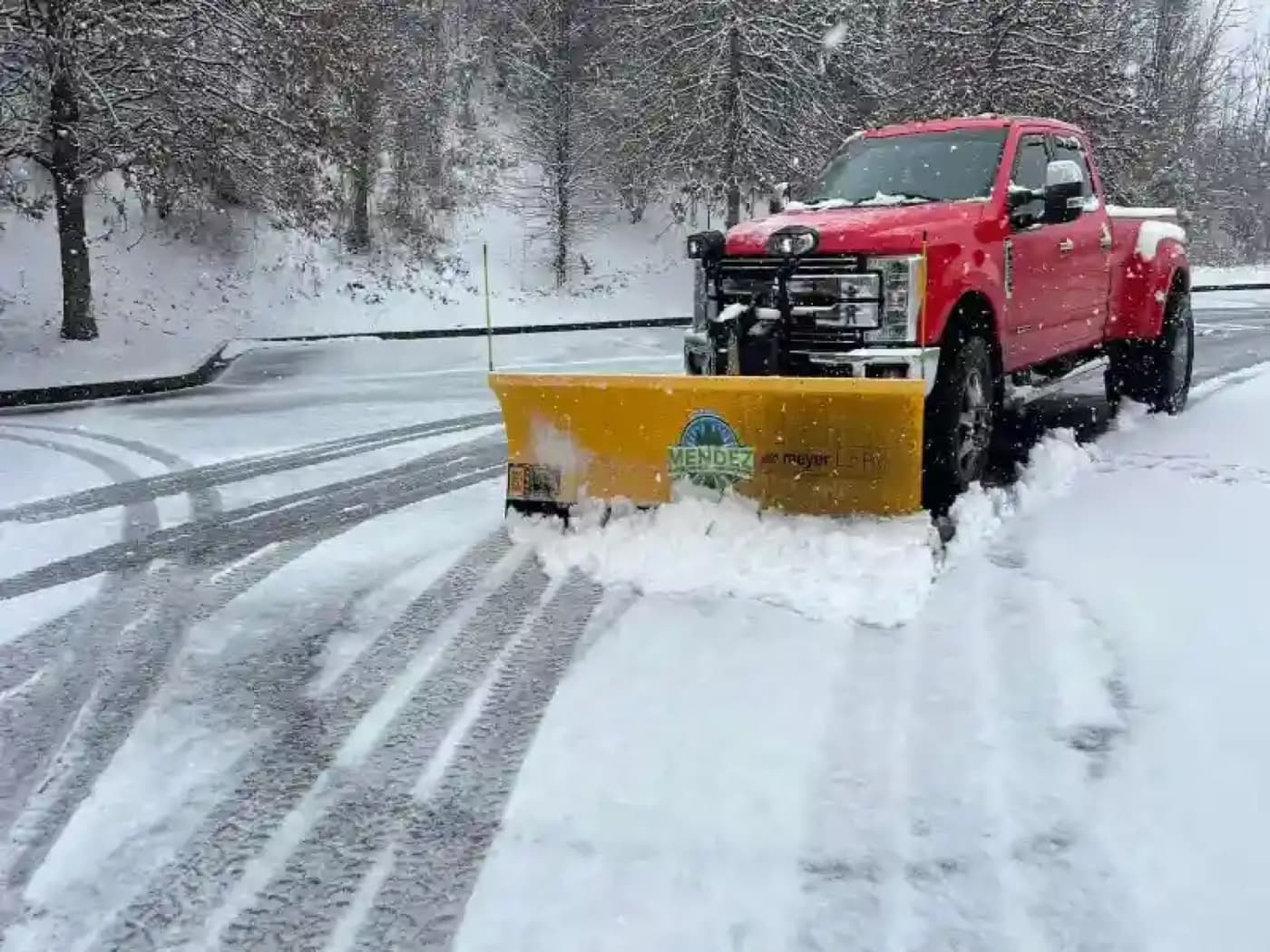 Mendez snow plow clearing a lot in Johnson City, TN